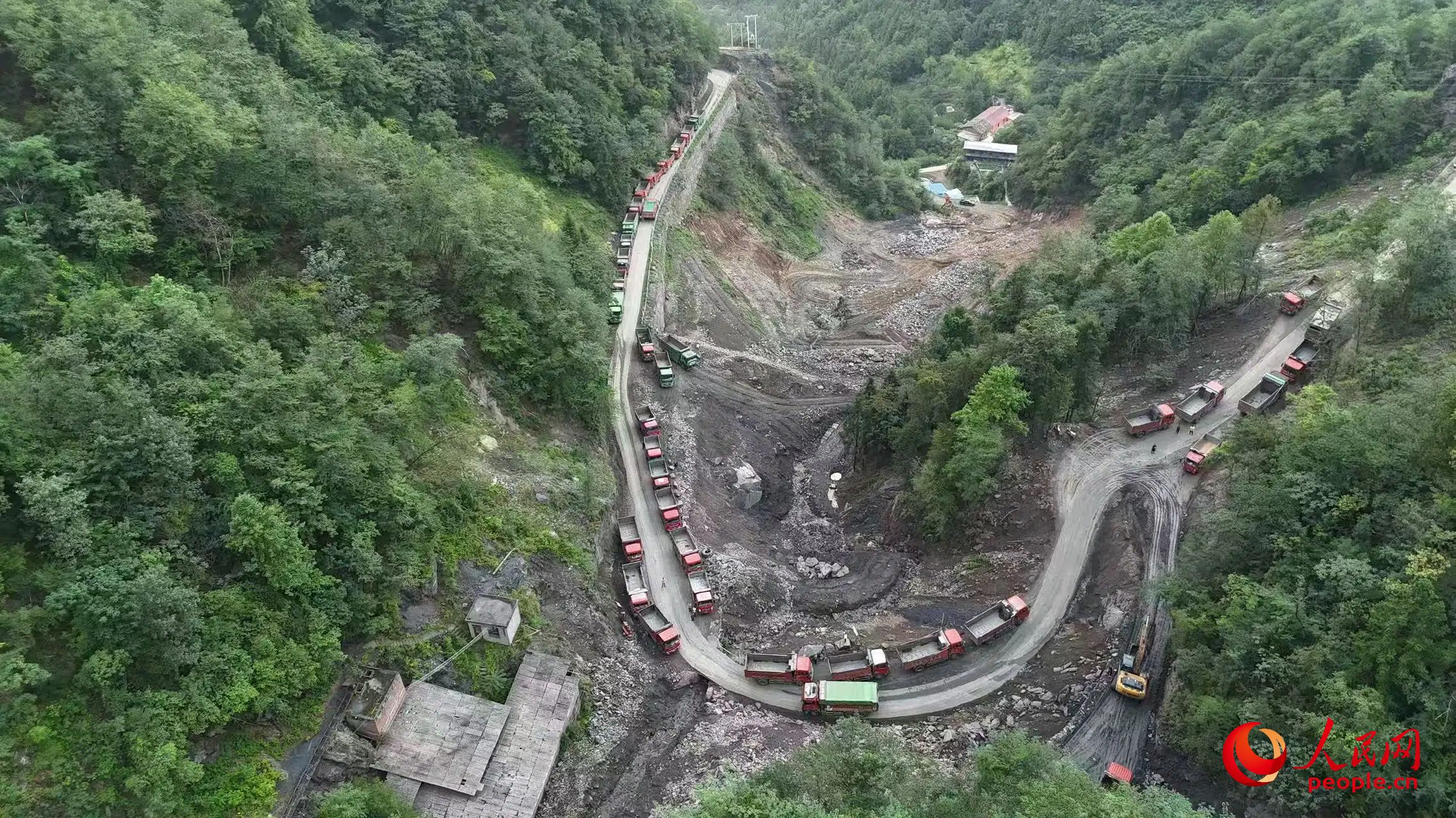 清运矿渣的卡车停在工区。受访者供图